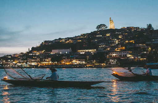 Candle-lit boats cross the water to the island of Janitzio, Michoacan