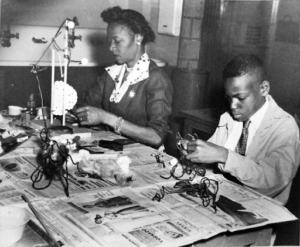 A mother and son duo working on art crafts at MoMA in 1954. Photo via the MoMA Archives.