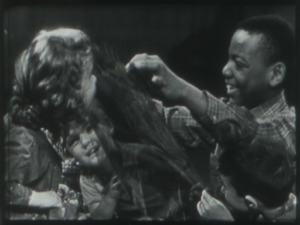 Children playing with blue cellophane. Still from Through the Enchanted Gate.