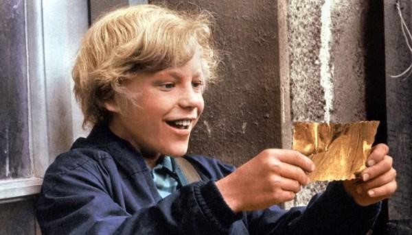 Charlie with his golden ticket in Willy Wonka and the Chocolate Factory.  Via roalddahl.fandom.com.